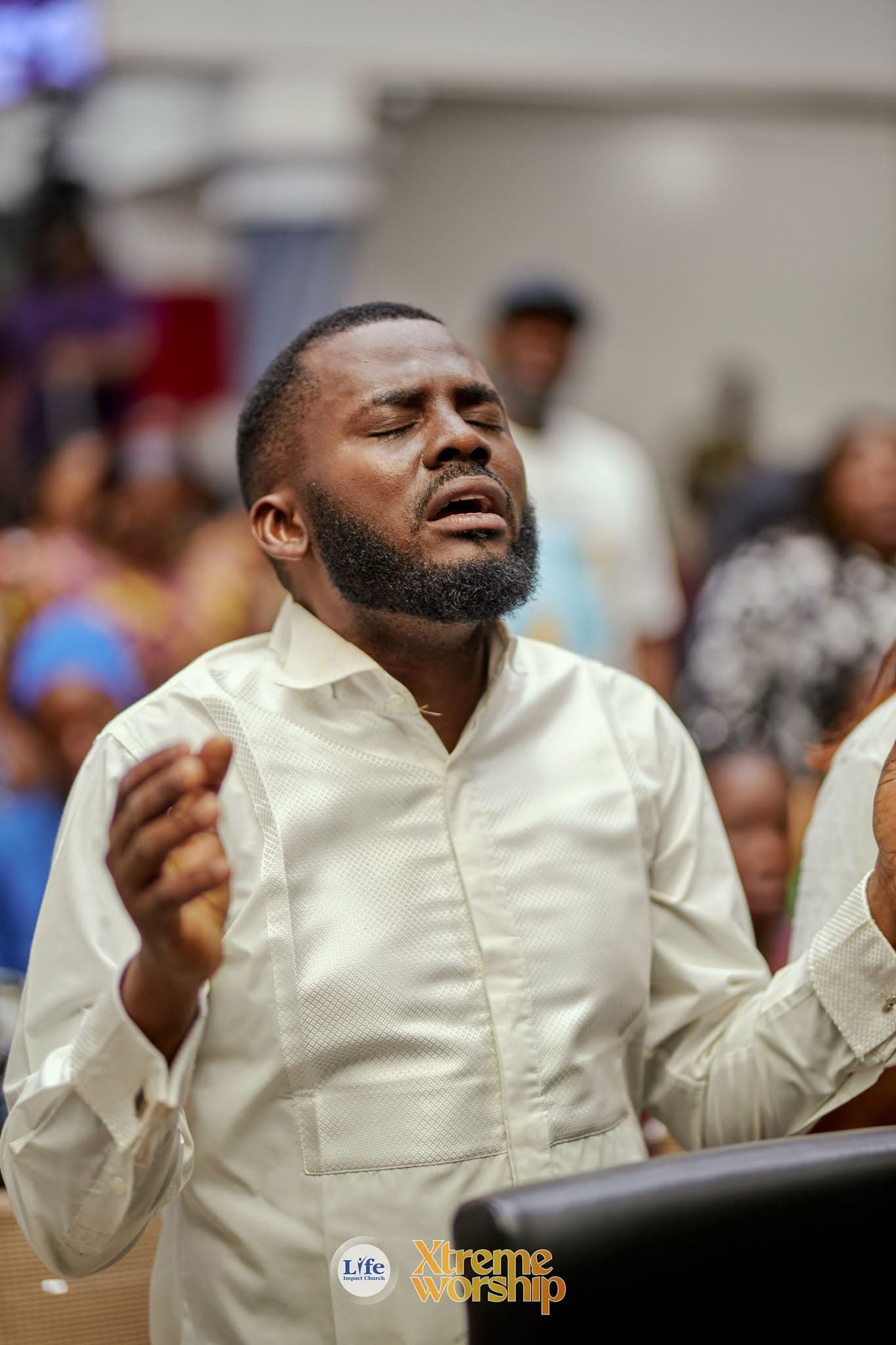 A man praying with his eyes closed during worship